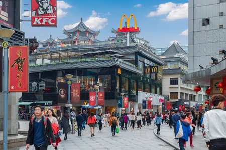 McDonalds resraurant at Shenzhen street in Chinese traditional building style.  Photo with blur in motion.  Shenzhen, China, 2018-03-08.のeditorial素材
