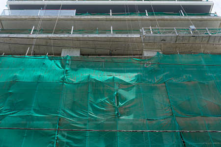 Safety construction net on the facade of the building. Protection from falling objects. Construction site.の写真素材