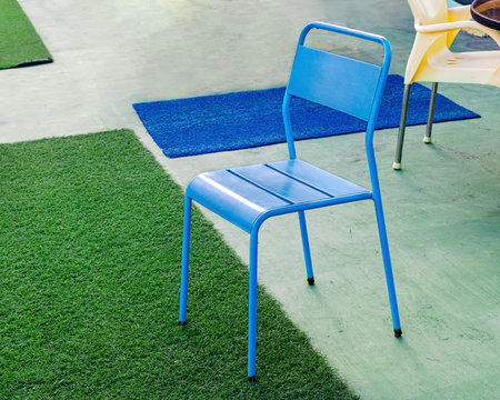 View of the  abstract interior -  a blue chair,  the carpet is divided into random parts.の写真素材