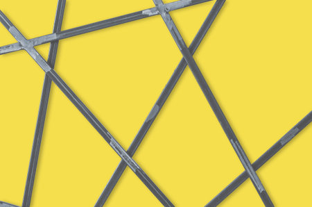 Metal geometric grid on yellow background. Abstract steel bars backdrop. Empty place for text, copy space.の写真素材