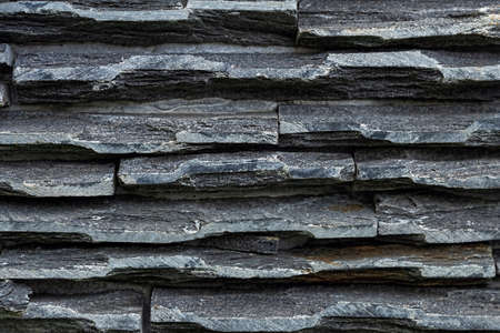 Dark wallpaper background use for ceramic wall and floor tile design. Natural stone pieces slate for interior designの写真素材