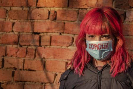 Girl with mask to protect her from Corona virus. Corona virus pandemic. Corona written on mask....