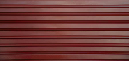 Red corrugated metal sheet texture background. Close-up.