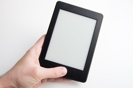 Hand holding blank ebook with empty screenの写真素材