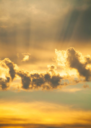 beautiful sunset with brightly illuminated rays of the sun clouds