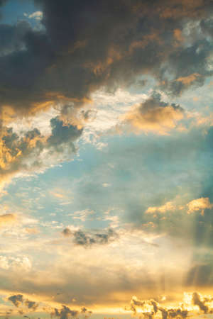 beautiful sunset with brightly illuminated rays of the sun cloudsの写真素材