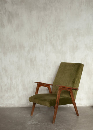 green cozy vintage armchair on a white wall backgroundの写真素材