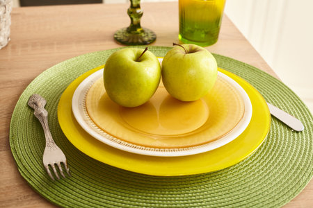 fresh, green apples are on the set tableの写真素材