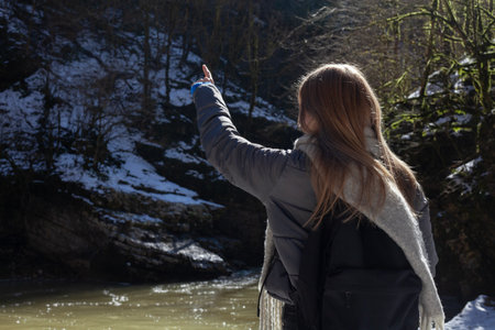 a woman stands near the river in warm clothes. Topics of an active lifestyleの写真素材