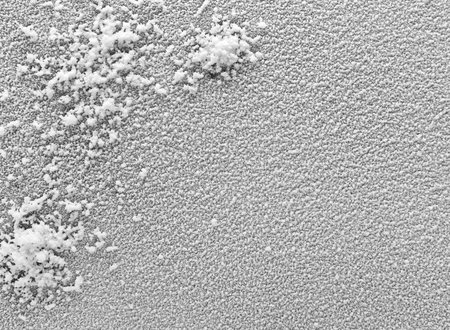 Black background covered with white artificial snow.
