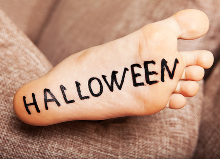 Foot with the inscription black Halloween.の写真素材