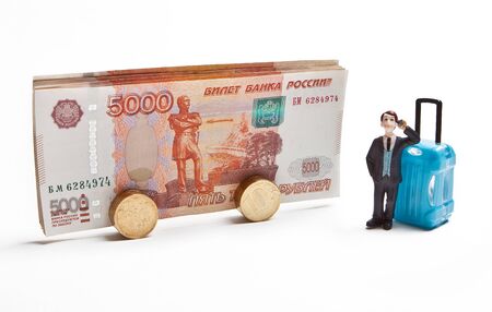 A traveler with a travel suitcase is waiting for boarding a bus from Russian money. The concept of tourism.の写真素材