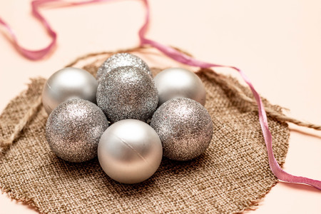 Flower from Christmas tree decorations on a canvas napkin Rope and pink ribbon. Side view.の写真素材