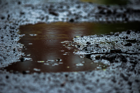 The road after the rain. Broken road. Puddle.の写真素材