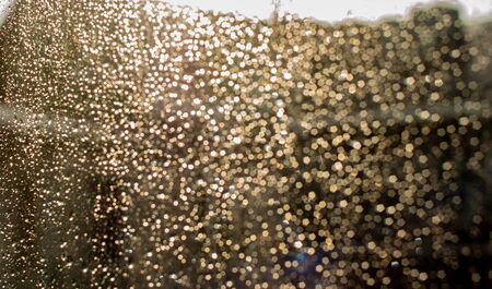 Raindrops on the glass. Drops of water in a glass. Glitter on glass from drops of water. Wet glass.の写真素材