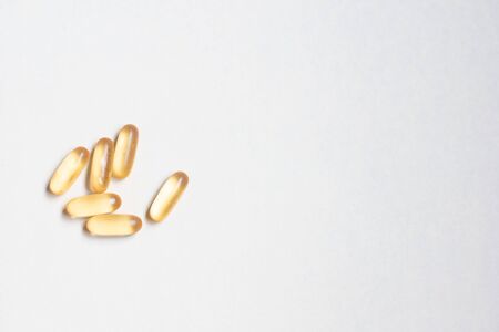 Dietary supplement omega on a white background.Capsule fish oil on a white background. Food supplement omega.の写真素材