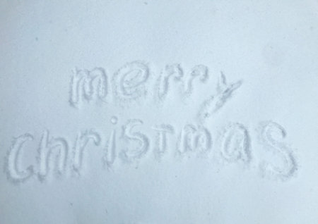Merry Christmas is written in the snow.の写真素材