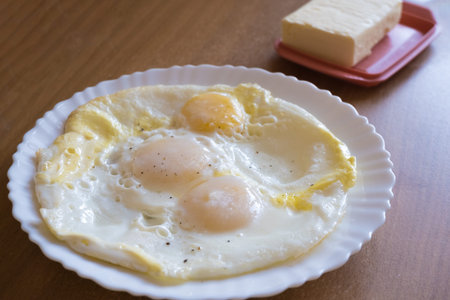 Fried eggs in a plate on the table. Breakfast on the table.