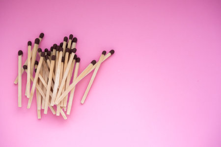 The matches lie on a pink background, a view of the top. There is a space for the text.の写真素材