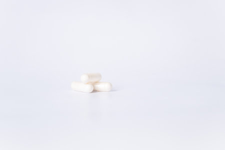 Three White Capsules on a White Background. There is space for text.の写真素材