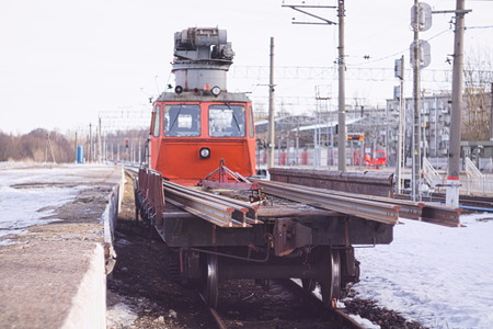Railway crane stands on the tracks near the platformの写真素材