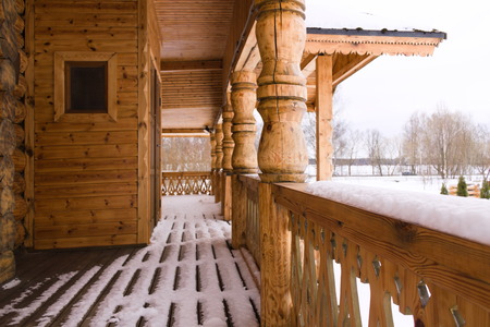 Terrassa wooden house covered in snowの写真素材