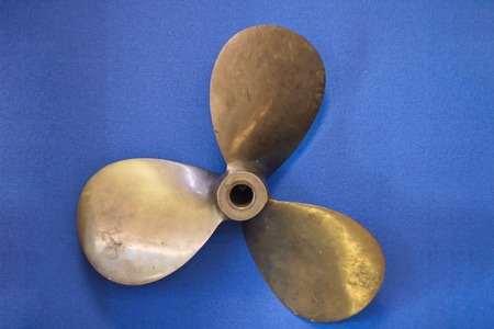 Bronze ship screw on a blue background with copy spaceの写真素材
