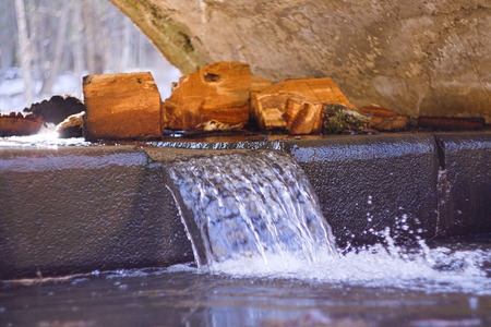 Sawn logs lie in a Jet fallsの写真素材