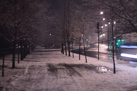 Snow on walkway along the streets at nightの写真素材