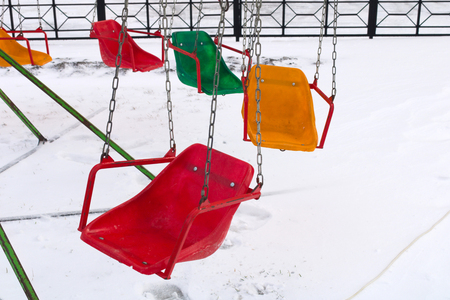 An empty children's carousel in winterの写真素材