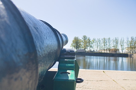 Old cast-iron cannon direct barrel into the bayの写真素材