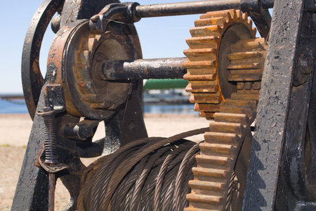 Rusty mechanical winch with gears covered with a lightweight web