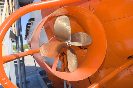 Side propeller and part of the board of the orange-white bathyscaphe on the warship desck close up.