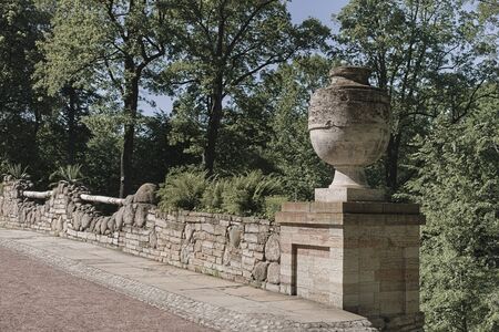 a huge stone vase adorns the railing of the ruin bridge in Alexandria park in Petergofの写真素材