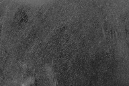 Background for notes. Black metal surface sprinkled with flour.の写真素材