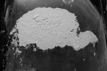 Handful of flour on a black background