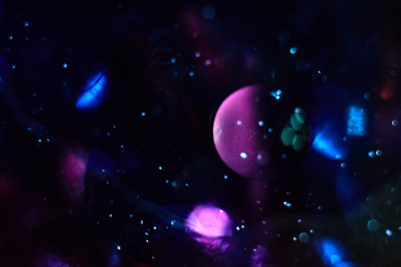 Outer space with planets galaxies stars and nebulae. Abstract bokeh background and oil bubbles.