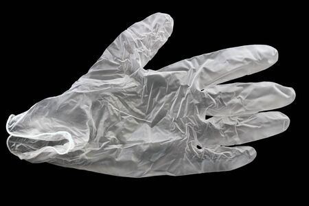 Shot white medical glove on a black background. Protection against viruses and germsの写真素材