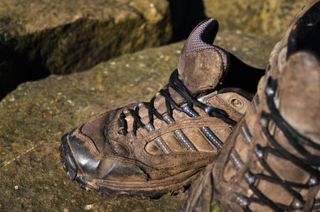 Old walking shoes on stone