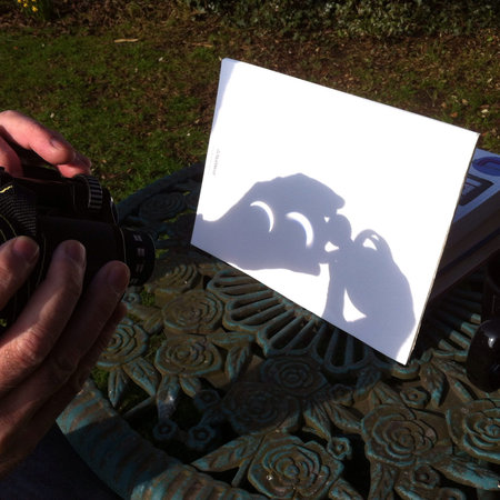 Solar eclipsed projected through reversed binoculars to protect eye sight