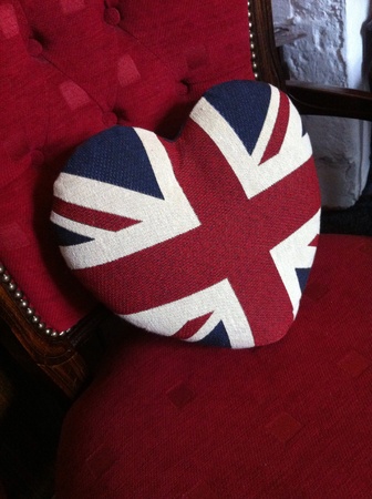 Heart shaped Union Jack cushion on red traditional chairの素材