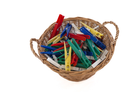 Basket of clothes pegs from above on white background.の写真素材