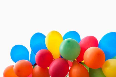 Colored party balloons against white background.の写真素材