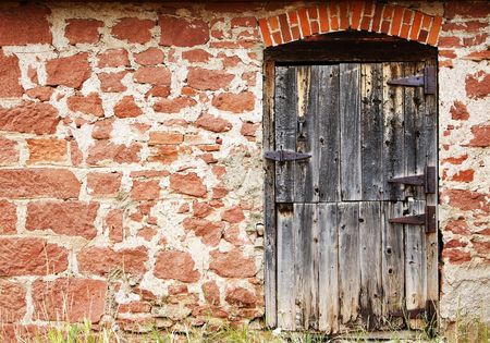 Old wooden door in a stone wall from authentic 19th century American West architecture in Colorado.の写真素材