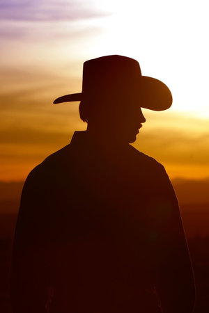 Cowboy silhouette against a sunset skyの写真素材