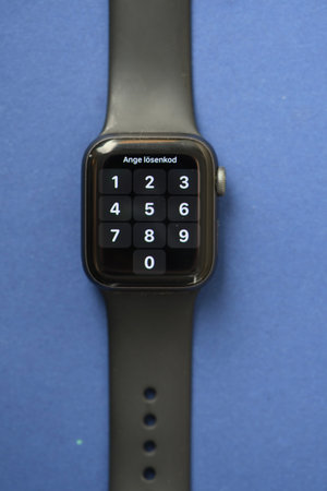 Overhead of a modern watch with touch screen on blue background