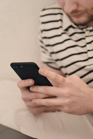 A man using his phone to text