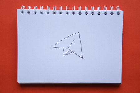 Overhead photo of a drawing of an airplane on red backgroundの写真素材