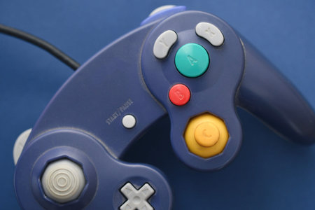 Photo of a gaming controller on blue backgroundの写真素材
