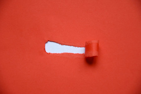 Overhead of a red paper with an empty hole with copy spaceの写真素材